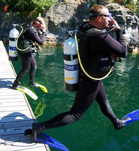 Scuba Divers Jumping Into Water